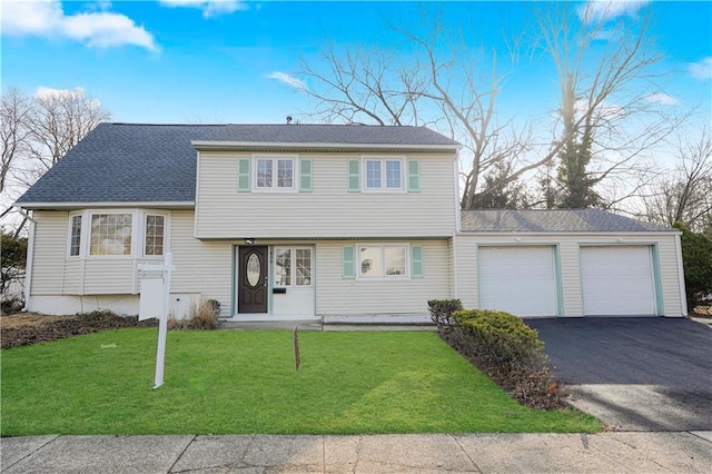 tri-level home featuring a garage, roof with shingles, a front lawn, and aphalt driveway