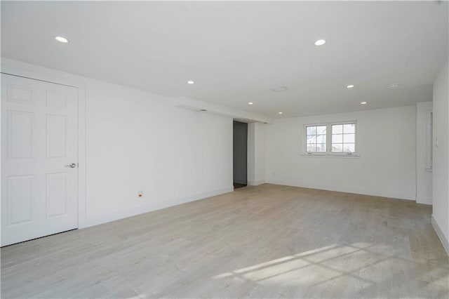 spare room with light wood-style flooring, recessed lighting, and baseboards