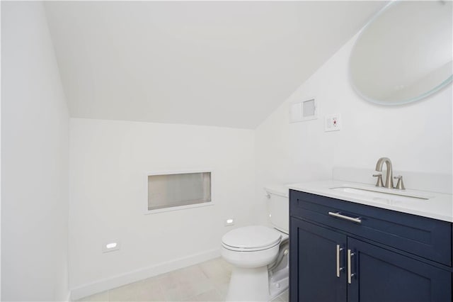 bathroom with visible vents, toilet, baseboards, lofted ceiling, and vanity