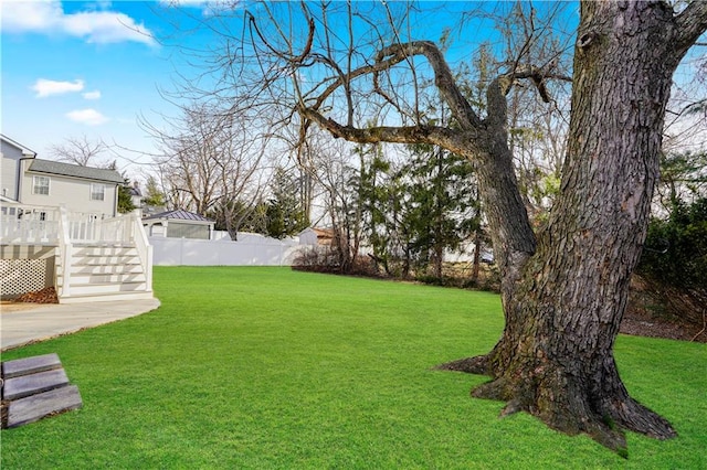 view of yard with a wooden deck and fence