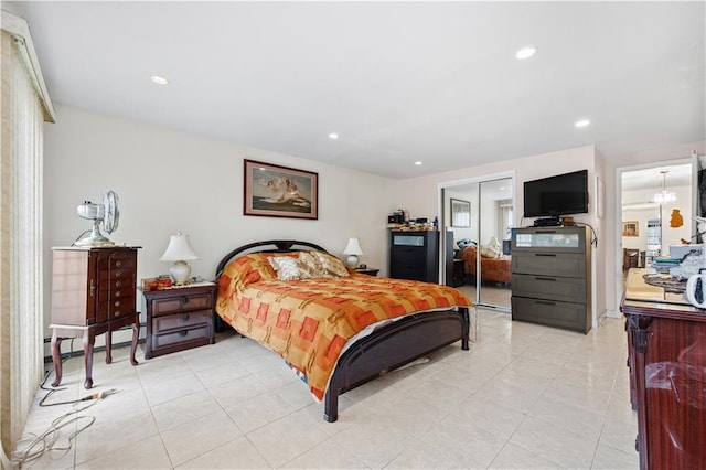 bedroom with recessed lighting, a closet, baseboard heating, and light tile patterned floors