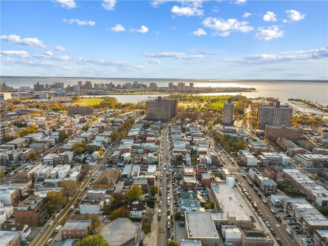 drone / aerial view featuring a view of city and a water view