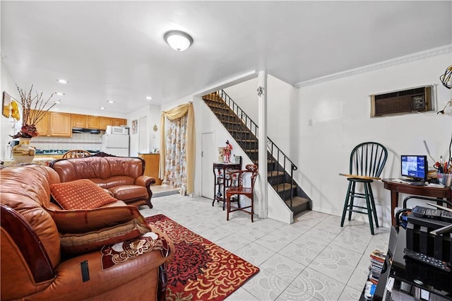 living room with a wall unit AC, stairway, light tile patterned floors, and baseboards