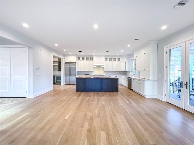 859 Lamont Ave, Staten Island, NY 10309 - kitchen featuring stainless steel appliances, french doors, white cabinets, baseboards, and light wood-style floors