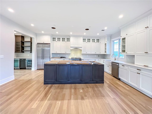 859 Lamont Ave, Staten Island, NY 10309 - kitchen featuring appliances with stainless steel finishes, beverage cooler, wooden counters, white cabinetry, and recessed lighting