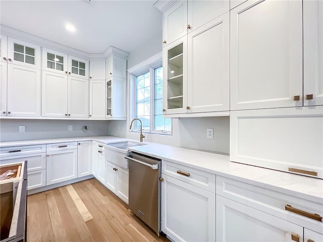 kitchen featuring light wood finished floors, white cabinetry, a sink, glass insert cabinets, and dishwasher