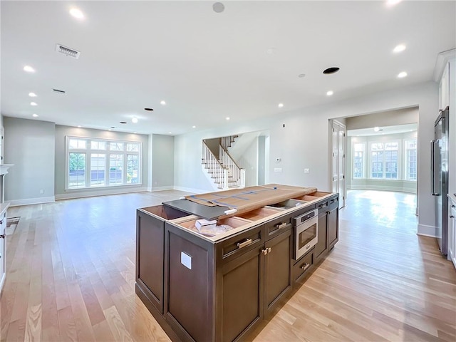 859 Lamont Ave, Staten Island, NY 10309 - kitchen featuring a center island, light wood-style floors, recessed lighting, open floor plan, and dark brown cabinets