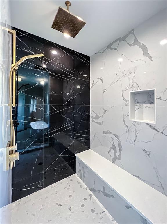 full bath featuring a marble finish shower