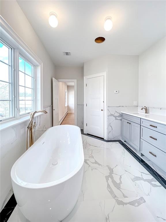 859 Lamont Ave, Staten Island, NY 10309 - bathroom featuring a freestanding tub, marble finish flooring, and vanity