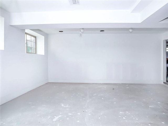 unfurnished room with visible vents and unfinished concrete floors