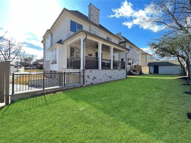 view of side of property featuring a lawn, a chimney, ceiling fan, and fence