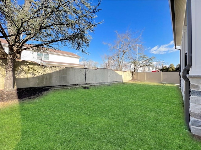 view of yard with a fenced backyard