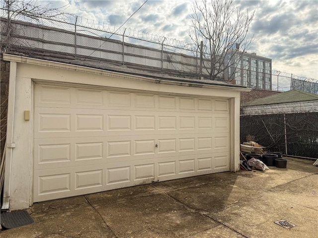 garage featuring concrete driveway