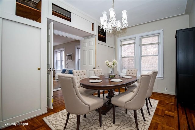 dining room featuring a chandelier and baseboards