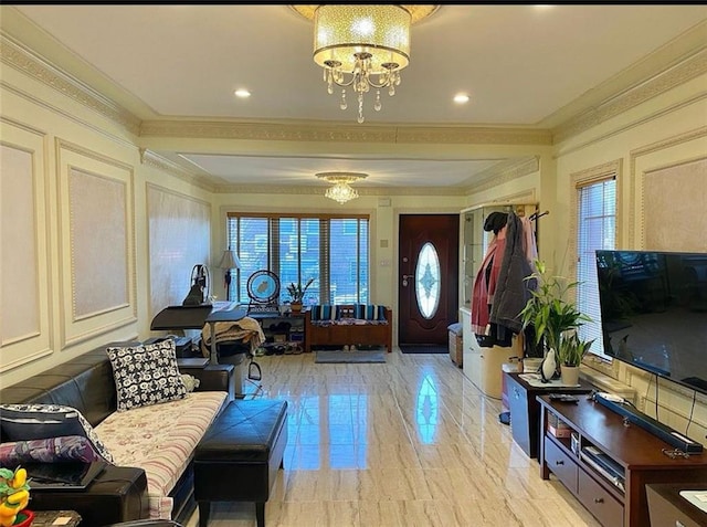 foyer with a chandelier, marble finish floor, and crown molding