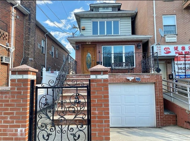 view of front facade with a garage, a gate, brick siding, and a fenced front yard