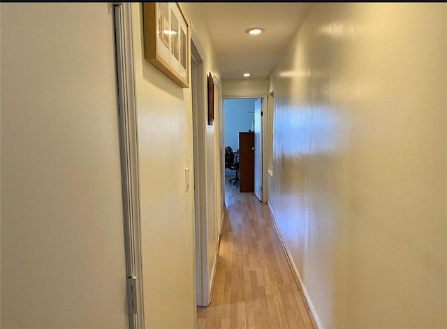 hallway with baseboards and light wood finished floors