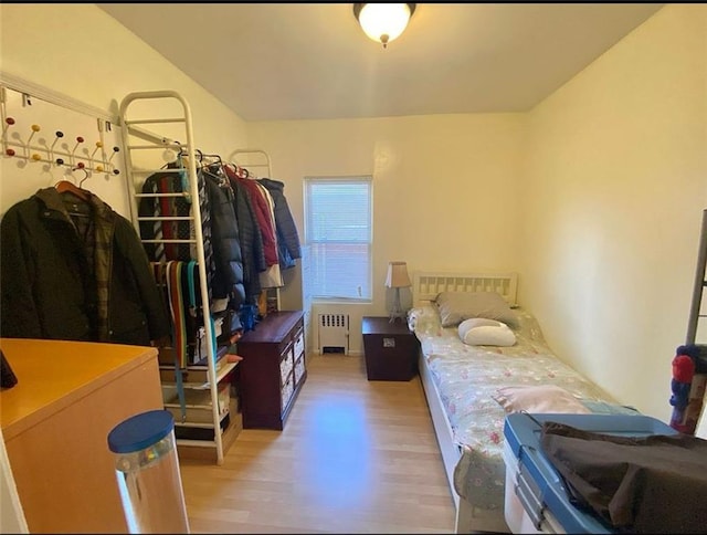 bedroom with light wood finished floors and radiator