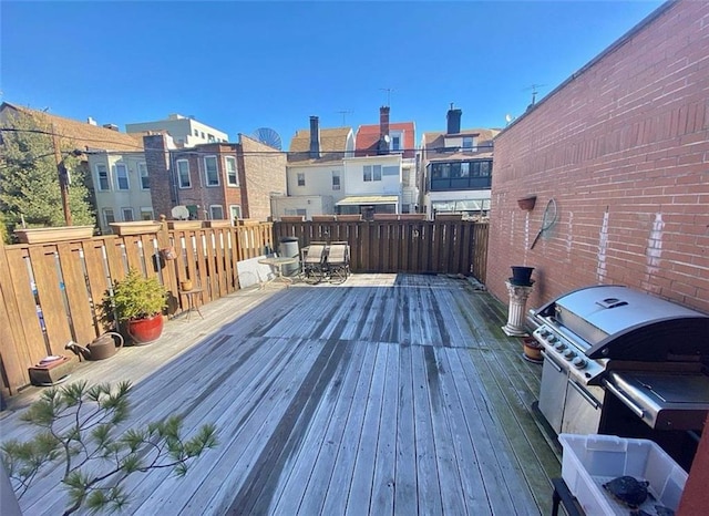 deck featuring grilling area and a residential view