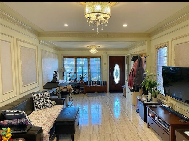 entryway featuring plenty of natural light, marble finish floor, an inviting chandelier, and ornamental molding