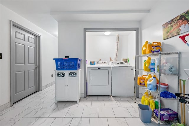 laundry area featuring marble finish floor, laundry area, and washer and clothes dryer