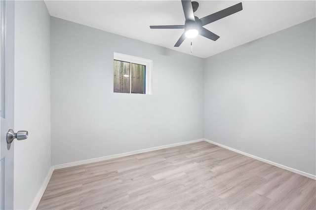 empty room featuring a ceiling fan, wood finished floors, and baseboards