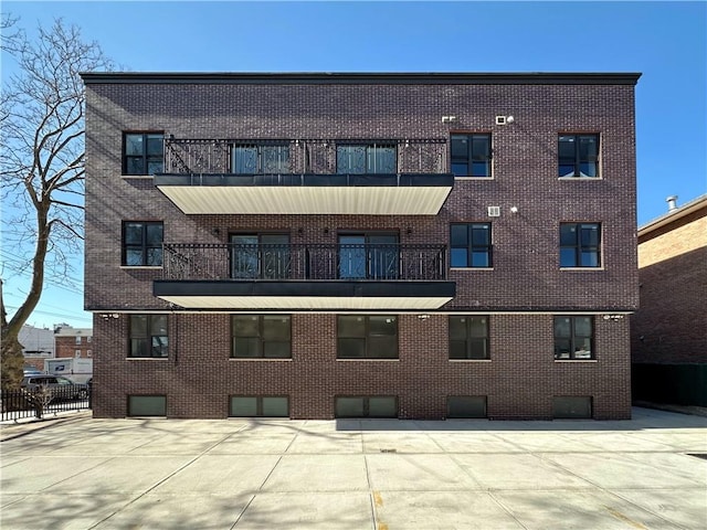 view of building exterior with fence