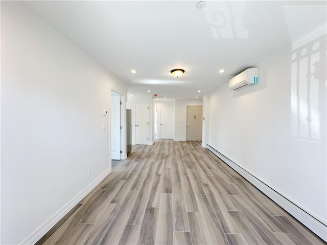 interior space with baseboards, wood tiled floor, recessed lighting, an AC wall unit, and baseboard heating