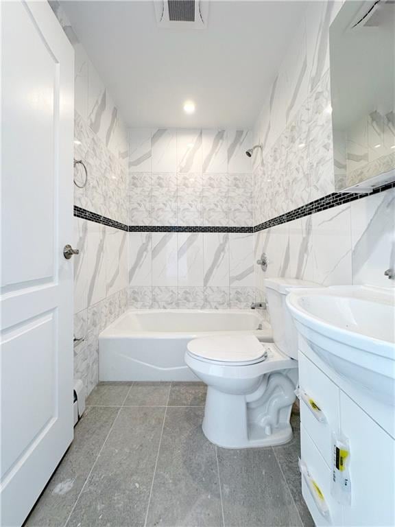 full bathroom with visible vents, tub / shower combination, toilet, vanity, and tile walls