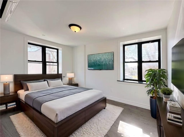 bedroom with baseboards and dark wood-style floors