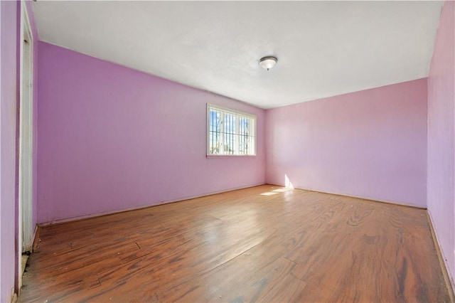 unfurnished room with wood finished floors