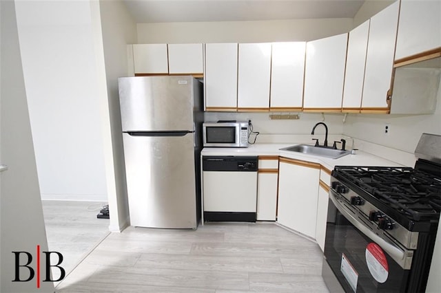 1121 E 73rd St Unit 69, Brooklyn, NY 11234 - kitchen featuring stainless steel appliances, a sink, light countertops, light wood-style flooring, and white cabinetry