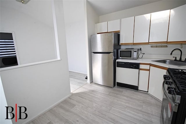 1121 E 73rd St Unit 69, Brooklyn, NY 11234 - kitchen featuring stainless steel appliances, light countertops, white cabinets, and light wood-style flooring