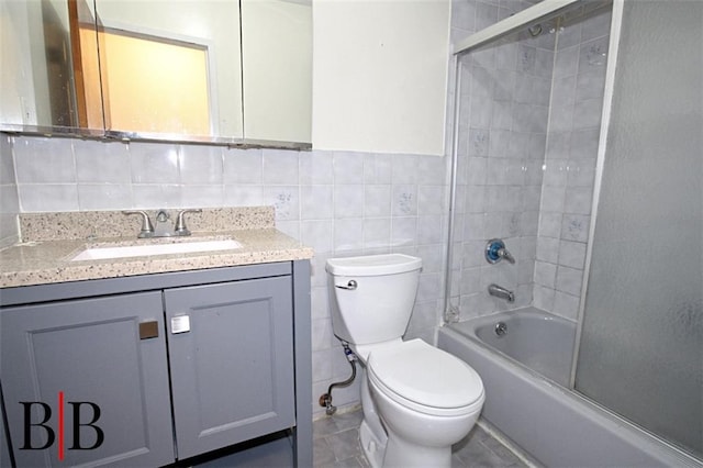 1121 E 73rd St Unit 69, Brooklyn, NY 11234 - full bathroom with tile walls, toilet, vanity, bathtub / shower combination, and a wainscoted wall
