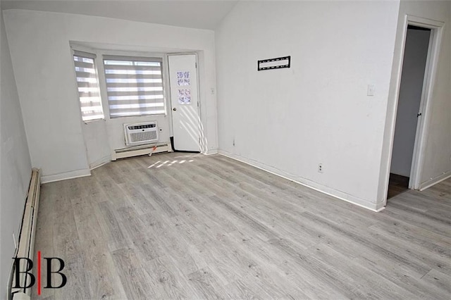 1121 E 73rd St Unit 69, Brooklyn, NY 11234 - unfurnished room featuring a baseboard radiator, wood finished floors, an AC wall unit, and lofted ceiling