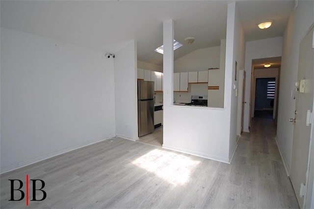 1121 E 73rd St Unit 69, Brooklyn, NY 11234 - unfurnished living room with lofted ceiling and light wood-style flooring