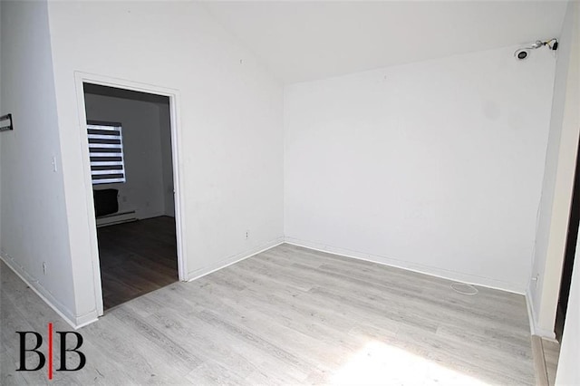 1121 E 73rd St Unit 69, Brooklyn, NY 11234 - unfurnished room with baseboard heating, light wood-type flooring, vaulted ceiling, and baseboards