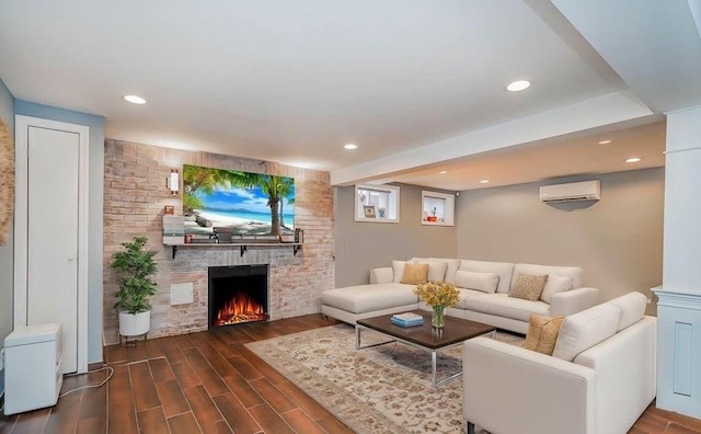 living room with recessed lighting, a fireplace, dark wood-type flooring, and a wall unit AC