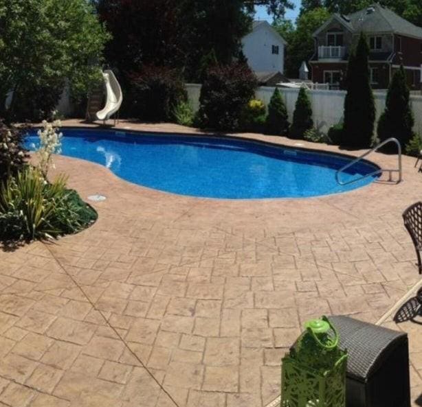 outdoor pool featuring a patio, a water slide, and fence