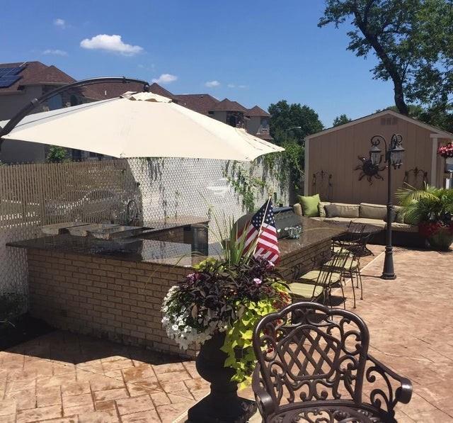 view of patio featuring an outbuilding and fence