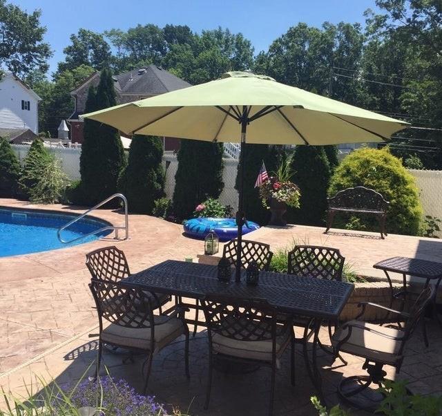 outdoor pool featuring a patio, outdoor dining area, and fence