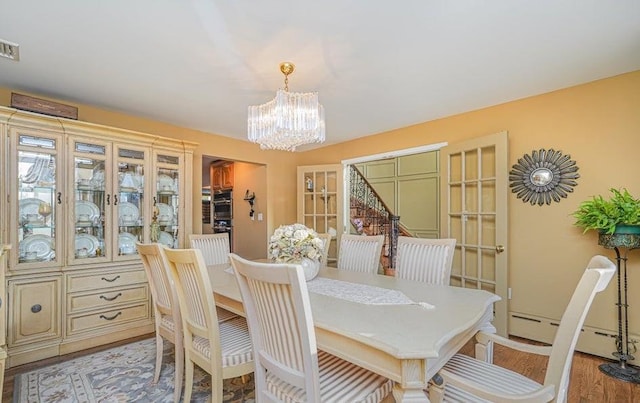 dining room featuring an inviting chandelier and light wood finished floors