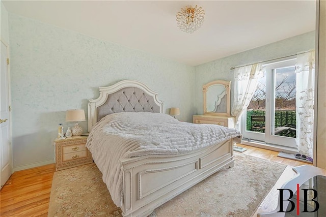 bedroom with light wood-style flooring and baseboards