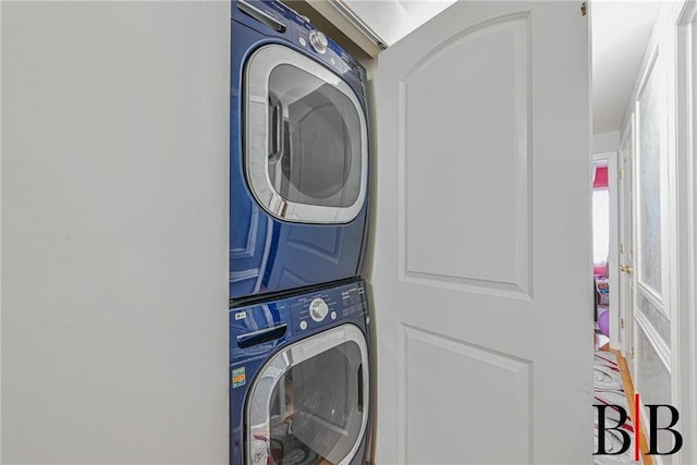 washroom featuring laundry area and stacked washing maching and dryer