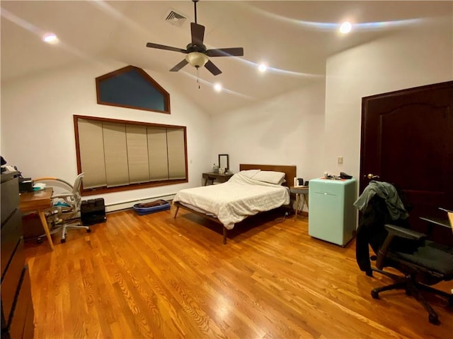 bedroom with a ceiling fan, wood finished floors, visible vents, vaulted ceiling, and fridge