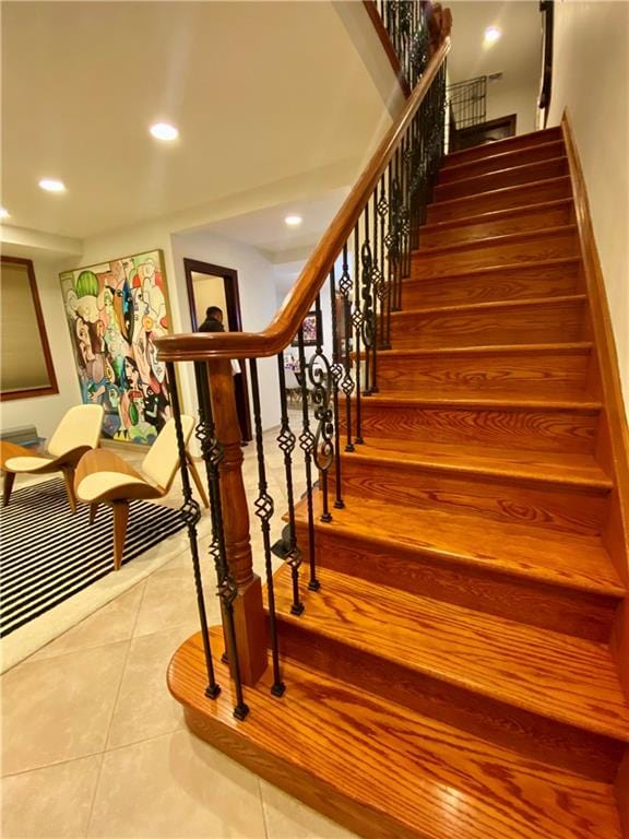 stairway featuring tile patterned flooring and recessed lighting