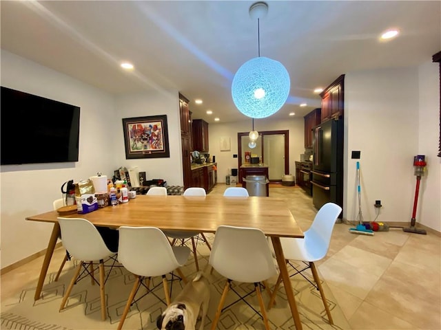 dining room with recessed lighting and baseboards