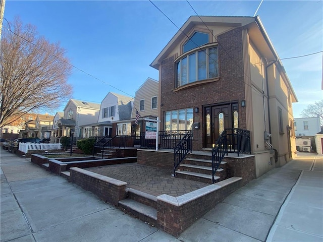 view of front facade with brick siding and a residential view