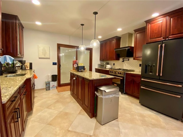 kitchen with tasteful backsplash, recessed lighting, high quality appliances, and wall chimney range hood