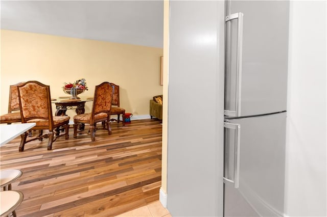 living area with baseboards and light wood-style floors